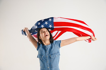 Image showing Young woman with the flag of United States of America