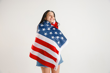 Image showing Young woman with the flag of United States of America