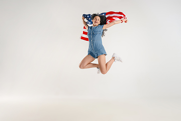 Image showing Young woman with the flag of United States of America