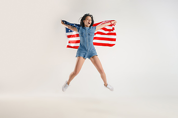 Image showing Young woman with the flag of United States of America