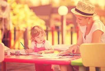 Image showing mom and little daughter drawing a colorful pictures