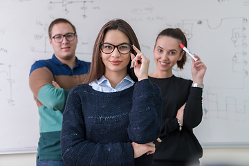 Image showing portrait of young students in front of chalkboard