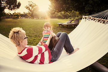 Image showing mom and a little daughter relaxing in a hammock