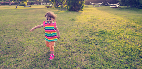 Image showing little girl spending time at backyard