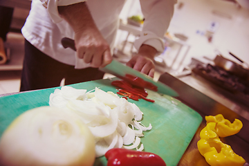 Image showing Chef hands cutting fresh and delicious vegetables