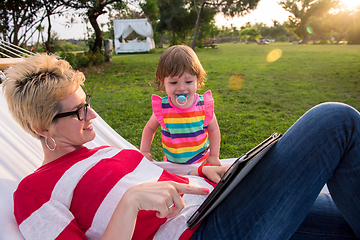 Image showing mom and a little daughter relaxing in a hammock