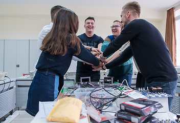 Image showing students celebrating successfully finished project