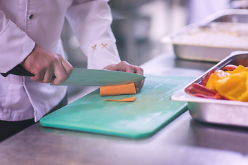 Image showing Chef hands cutting fresh and delicious vegetables