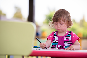 Image showing little girl drawing a colorful pictures