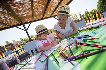 Image showing mom and little daughter drawing a colorful pictures