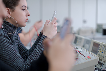 Image showing female student using a mobile phone