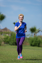 Image showing young female runner training for marathon