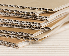 Image showing Cardboard pile on corrugated background