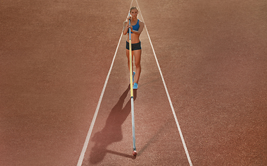 Image showing Female high jumper training at the stadium in sunny day