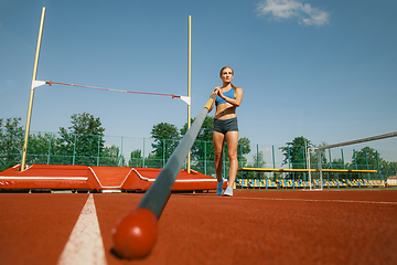 Image showing Female high jumper training at the stadium in sunny day