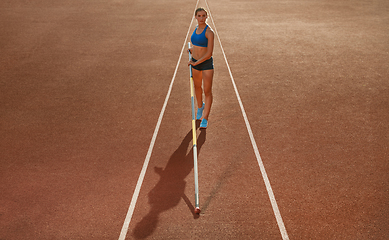 Image showing Female high jumper training at the stadium in sunny day