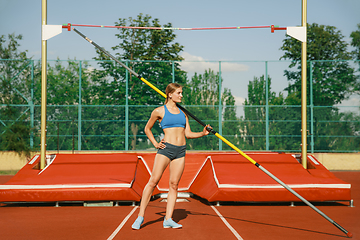 Image showing Female high jumper training at the stadium in sunny day