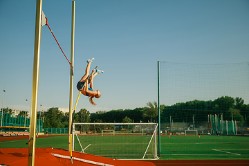 Image showing Female high jumper training at the stadium in sunny day