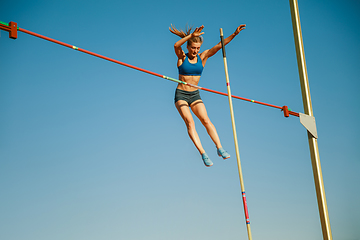 Image showing Female high jumper training at the stadium in sunny day