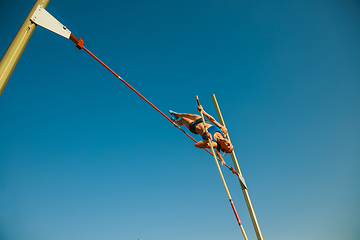 Image showing Female high jumper training at the stadium in sunny day