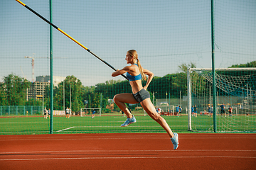 Image showing Female high jumper training at the stadium in sunny day