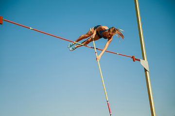 Image showing Female high jumper training at the stadium in sunny day