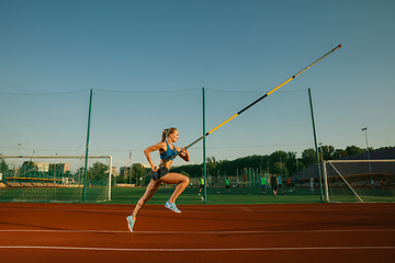 Image showing Female high jumper training at the stadium in sunny day