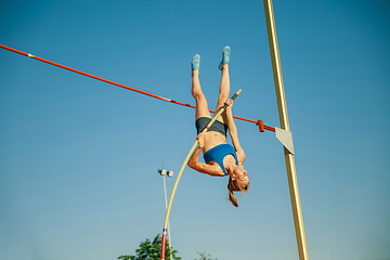 Image showing Female high jumper training at the stadium in sunny day