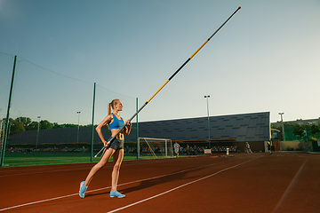 Image showing Female high jumper training at the stadium in sunny day