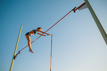 Image showing Female high jumper training at the stadium in sunny day