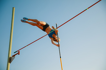 Image showing Female high jumper training at the stadium in sunny day