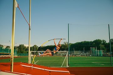 Image showing Female high jumper training at the stadium in sunny day