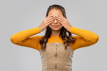 Image showing teenage girl closing her eyes by hands