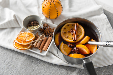 Image showing pot with hot mulled wine, orange slices and spices