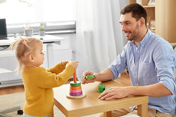 Image showing father playing with little baby daughter at home