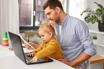 Image showing working father with baby daughter at home office