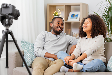 Image showing couple of video bloggers with camera at home