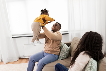 Image showing african father playing with baby daughter at home