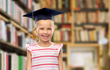 Image showing girl in bachelor hat or mortarboard at library