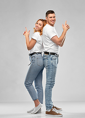 Image showing couple in white t-shirts shirts making gun gesture