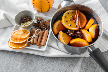 Image showing pot with hot mulled wine, orange slices and spices