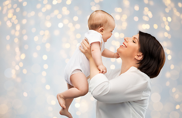 Image showing happy middle-aged mother with little baby daughter