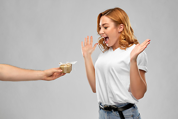 Image showing happy couple in white t-shirts with christmas gift