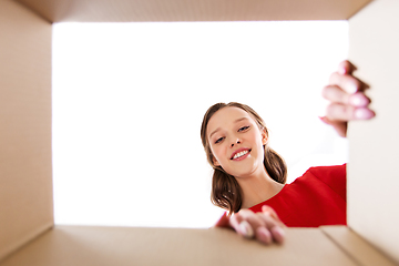 Image showing happy young woman looking into open gift box