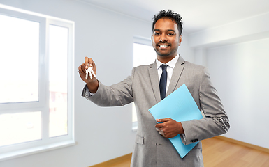 Image showing indian man realtor with key and folder at new home