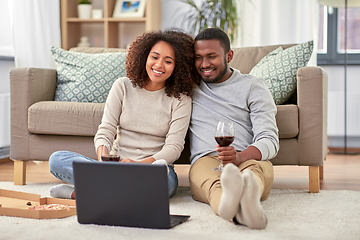 Image showing happy couple with laptop drinking red wine at home