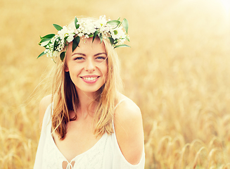 Image showing happy young woman in flower wreath on cereal field