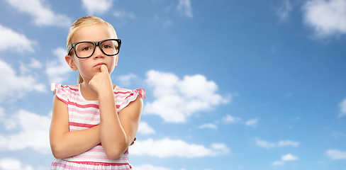 Image showing girl in glasses thinking over sky background