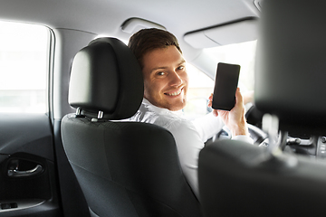 Image showing man or car driver showing smartphone