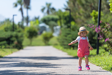 Image showing little girl runing in the summer Park